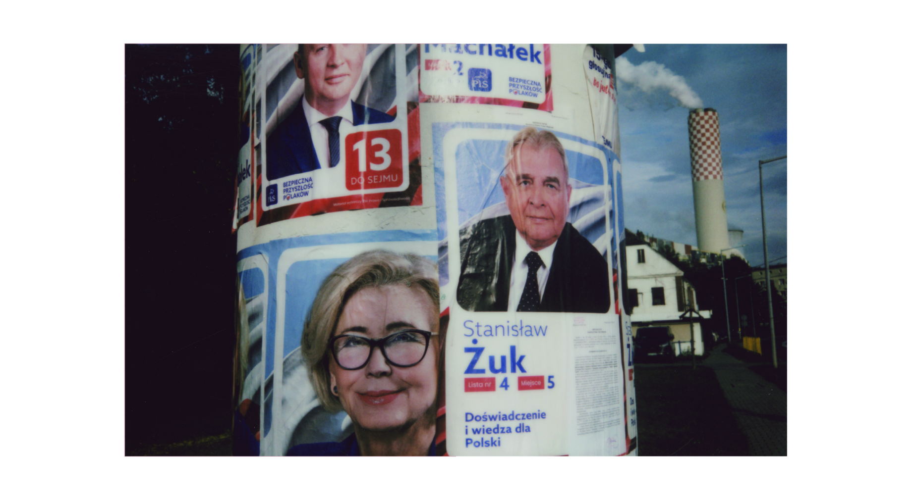 Instax photo of political banners with politicians' faces glued to a column