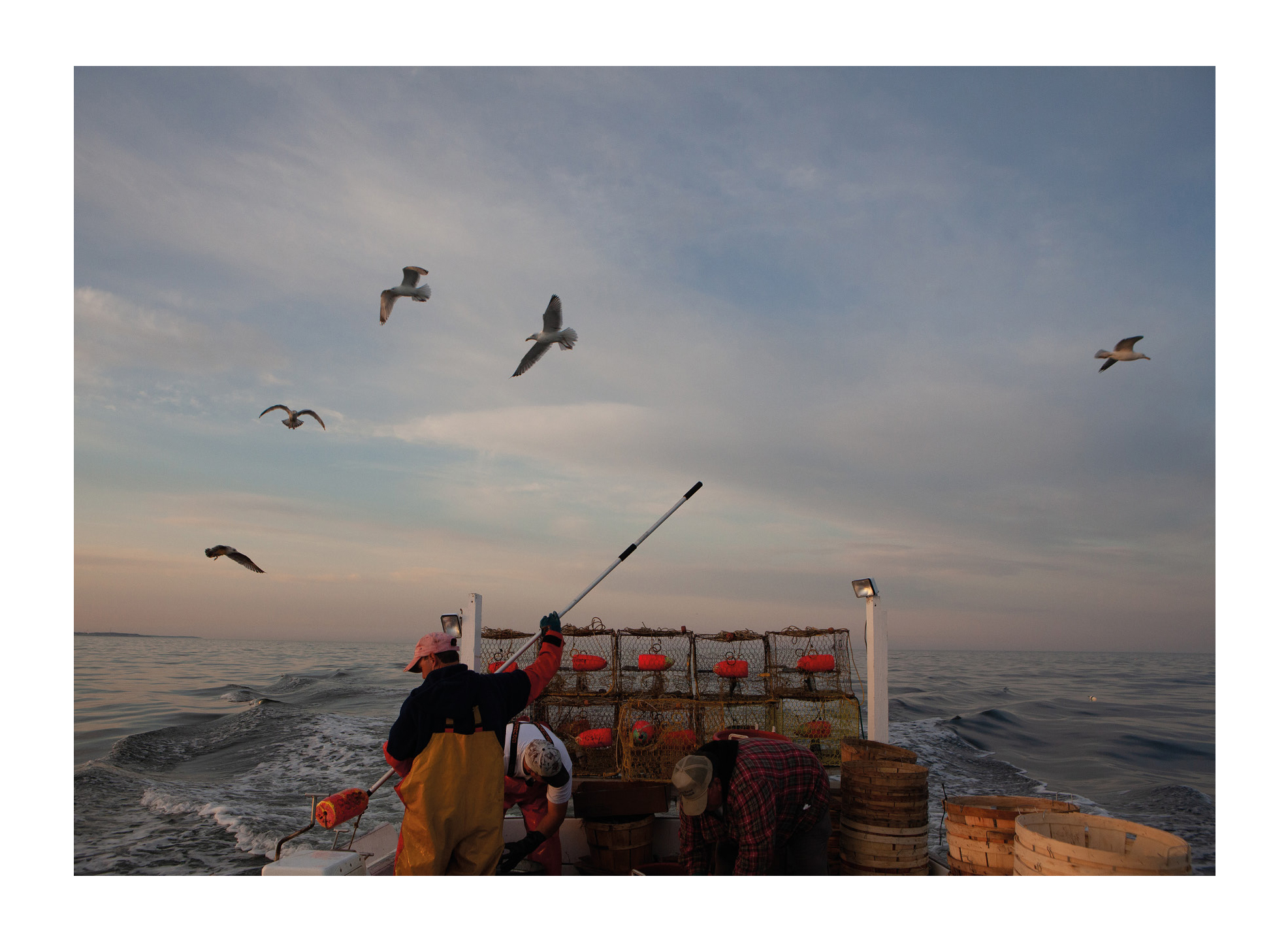Photograph from Tangier Island photography zine showing waterman working on his boat